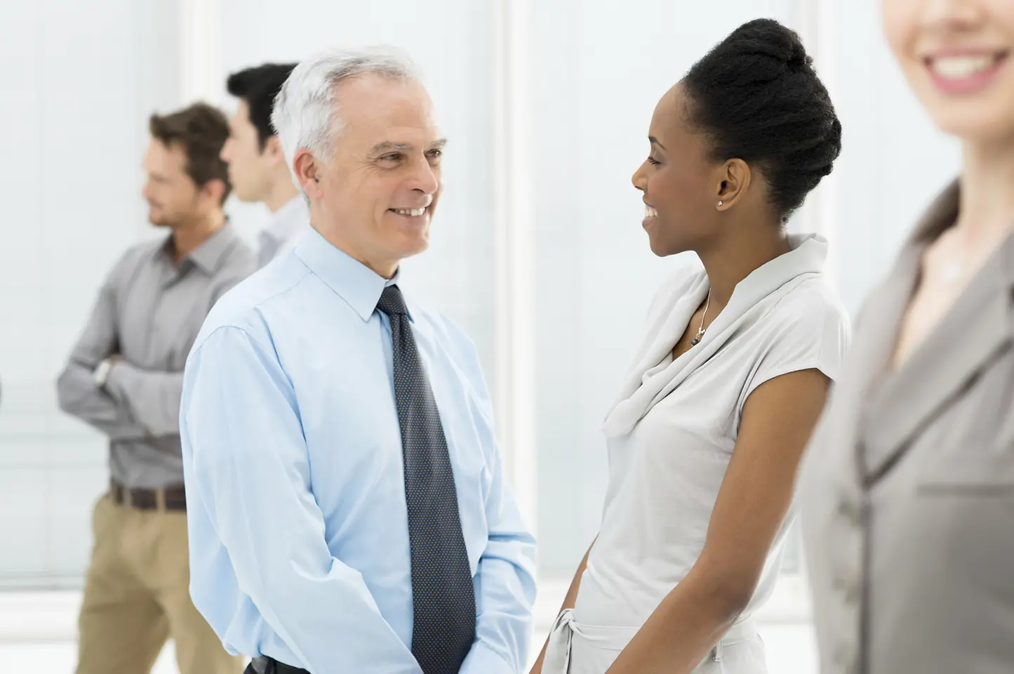 Older man talking to young woman