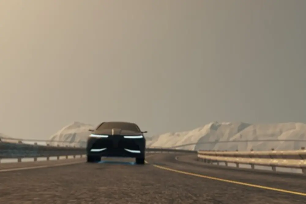 Autó halad az úton havas hegyekkel a háttérben