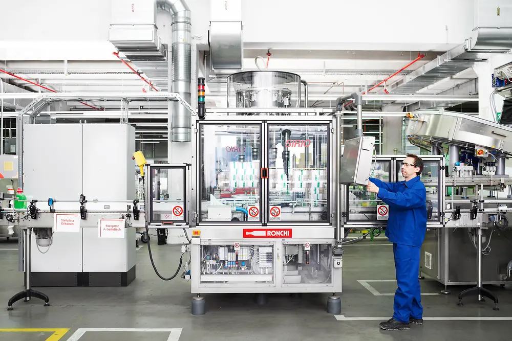 An employee in Duesseldorf is filling detergent at the production line.